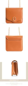 Detailed view of the brown mini crossbody bag showing gold chain strap and metal round buckle.