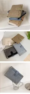 Stylish denim passport cover wallet with snap button and metal studs for women travel.