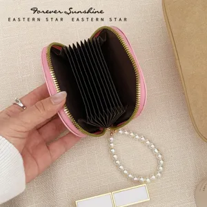 Pink PU leather accordion card holder with elegant pearl bracelet strap, multi-slot wallet.