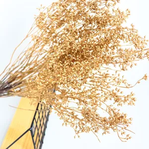 Detail shot of golden dried millet fruit bouquet branches for floral arrangement and decor.