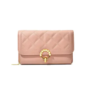 Elegant women's pink quilted long wallet crossbody bag with stylish pearl ring clasp.