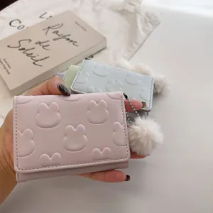 Cute trifold wallet for women short card holder with cute rabbit embossing and fluffy pom pom.