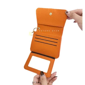 Orange leather short wallet card holder with multiple slots and clear ID window display.