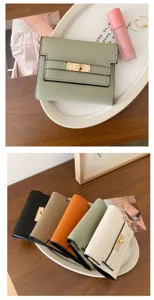Minimalist PU leather short wallet with metal turn-lock design for women daily use.