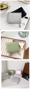 Detailed view of women's minimalist short wallet with cracked patent leather texture and zipper.