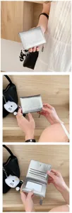 Korean style metallic silver short wallet with card slots and cute plush charm pendant.