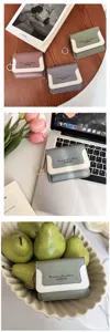 Mini PU leather coin purse with keychain and contrast color flap design for women daily use.