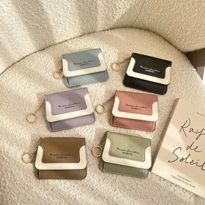 Mini leather coin purse for women, solid color minimalist wallet with keychain and snap closure.