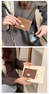 Detailed close-up view of the minimalist brown card holder showing premium texture and slots.