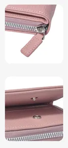 Pink leather wallet detail shot, showcasing fine stitching, metal zipper and snap button.
