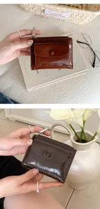 Brown crinkled leather short wallet detail showing zipper, snap pocket and multiple slots.
