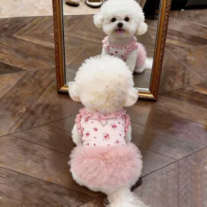 Detailed view of a cute spring summer floral dog dress with mesh tutu skirt and bow design.