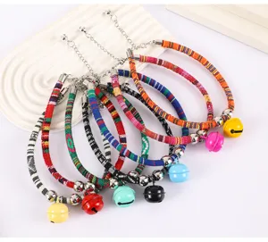 Colorful woven pet collar with bell and adjustable chain, detailed view of pet accessories.