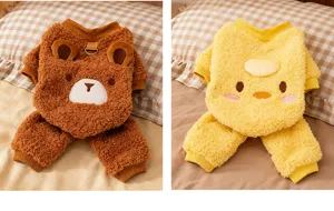 Close-up detail of cute winter warm pet fleece clothes with cartoon bear and duck designs.