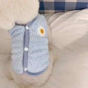 Close-up detail of thickened blue pet fleece vest with cute flower embroidery for small dogs.