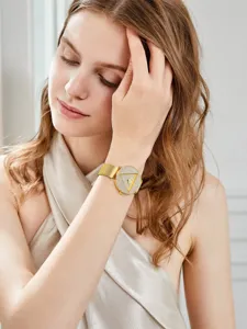 Elegante reloj de cuarzo para mujer con malla dorada y esfera de triángulo con pedrería.