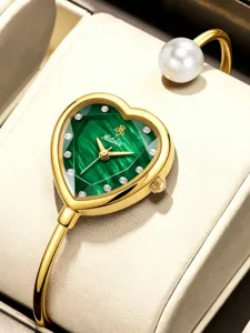 Close-up detail of the luxury heart-shaped green dial bangle watch with dazzling crystals.