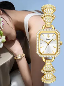Detailed view of luxury gold square dial women watch with sparkling rhinestones and delicate link.