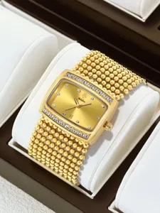 Detailed view of women's gold rectangular rhinestone watch with multi-strand beaded strap.