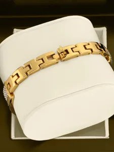 Close-up shot of the gold-colored link watch bracelet showcasing exquisite square metal links.
