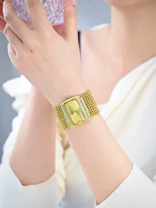 Elegant gold women's watch featuring a rectangular crystal-set dial and multi-strand beaded metal strap.