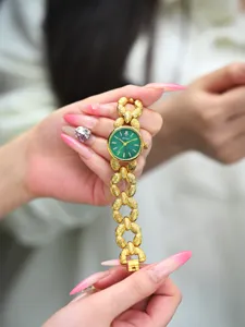 Orologio da donna di lusso oro con quadrante verde e un elegante cinturino a catena testurizzato.