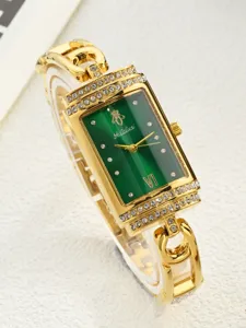 Detail view of a luxury green rectangular quartz watch with rhinestone bezel and gold chain strap.