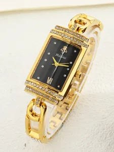 Close-up of rectangular quartz women watch, gold chain bracelet with rhinestones dial.