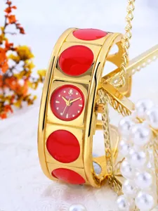 Gold cuff watch with red enamel circles and round dial. Elegant retro women watch.