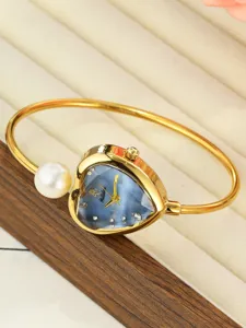 Exquisite heart-shaped dial watch with pearl bracelet, elegant gold women fashion timepiece.