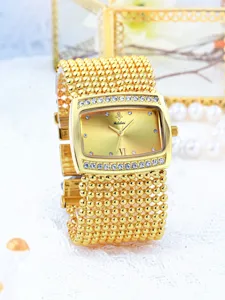 Gold-tone women's wristwatch with a crystal bezel, sunburst dial, and unique beaded strap.