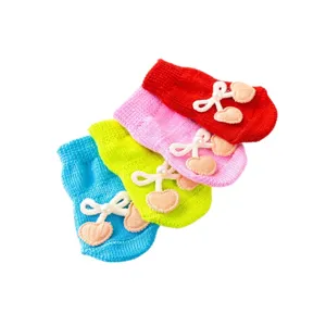 Colorful knit pet socks for small dogs and cats, anti-slip paw protectors with cute bow decor.