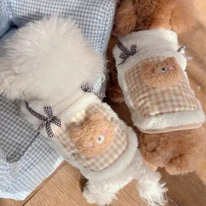 Close-up detail of cute pet winter fleece vest featuring a cozy plaid pocket and plush bear design.