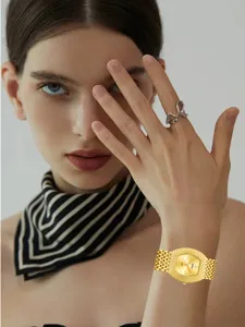 Luxury rhinestone tonneau quartz watch for women featuring sparkling dial and metal strap.