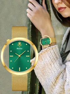 Yalalusi women quartz watch with green dial, gold mesh strap and hollow case design.