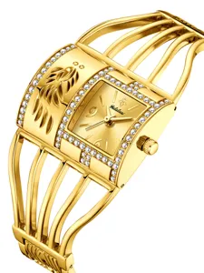 Elegante reloj pulsera mujer dorado con diamantes de estrás, correa de jaula y esfera pluma.