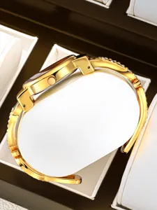 Luxury gold bangle women watch with sparkling rhinestones, elegant minimalist design for daily wear.