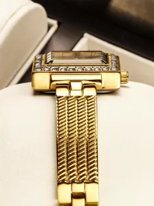 Exquisite detail view of women's gold vintage square rhinestone watch with mesh metal strap.