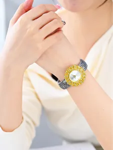 Luxury women quartz watch with floral bezel and textured leather strap detail shot