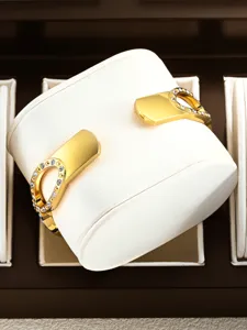 Detailed showcase of the elegant gold rhinestone bracelet watch on a white display pillow.