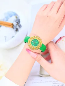 Detail view of Yalalusi luxury women watch, green dial, gold floral rhinestone bezel.