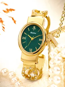 Elegant women's gold bracelet watch featuring a chic green oval dial and sparkling crystal strap.
