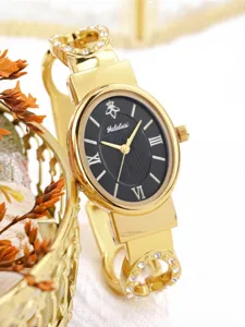 Close-up detail of women luxury bracelet watch, oval black dial, elegant rhinestones.