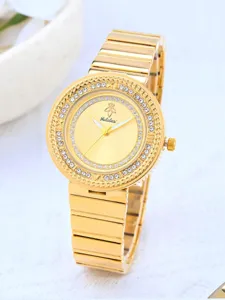 Détail de montre à quartz dorée avec lunette en strass étincelante et cadran élégant.