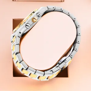 Detailed view of luxury two-tone quartz watch steel bracelet and crown design.