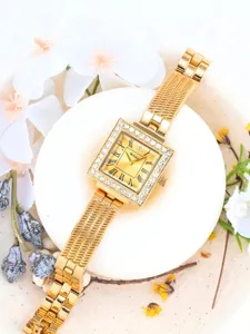 Detailed close-up of a luxury square rhinestone women watch with gold mesh strap.