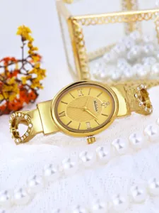Gold women watch luxury bracelet wristwatch detail view with rhinestones and elegant dial.