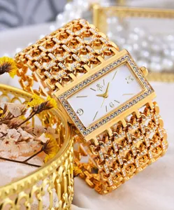 Luxus Gold Strass Quarz Damenuhr mit glitzerndem Kristallkettenarmband und weissem Zifferblatt.