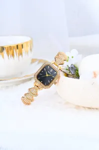Detail shot of a luxury gold-tone women watch with rhinestone dial and elegant fan link bracelet.