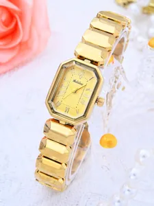 Vue rapprochée de l'élégante montre à quartz dorée pour femme au bracelet métallique géométrique.